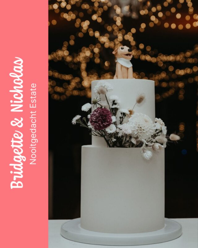 BRIDGITTE & NICHOLAS
…
An absolutely beautiful version of our Kate cake size for Bridgette & Nicholas’s wedding celebration at @nooitgedachtestate. Our Kate has a taller bottom tier, making this two tier cake tall and eye-catching, especially with a cute dog cake topper and pretty flowers like on this version!
…
Coordinated by @amocreative 
Photography by @sharynhodgesphotography 
Flowers provided by @emilybloom_za