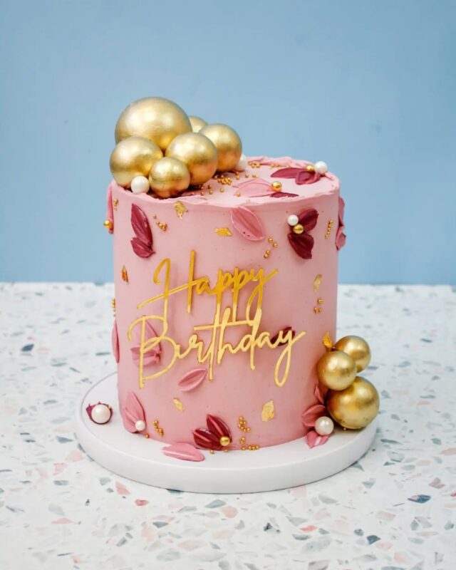 Help me settle a debate: Does this design deserve a forever spot on our online store?...​This bespoke celebration cake design featured smooth dusty rose / mauve buttercream with a textured top edge. It had buttercream petals and smears, with metallic gold spheres and a happy birthday charm. I absolutely love this colour combo btw! 😍...​This cake was originally created as a one-off custom piece, but I’m tempted to add it to our online store.......​Yay or Nay?? Let me know in the comments!!!...(If you need a bespoke cake for your next celebration get in touch via the link in our bio or via the link in the  Celebration Cake highlight here on our profile 🫶)...​#BespokeCakes #CelebrationCake  #CakeDesign #CustomCakes #CakeInspo